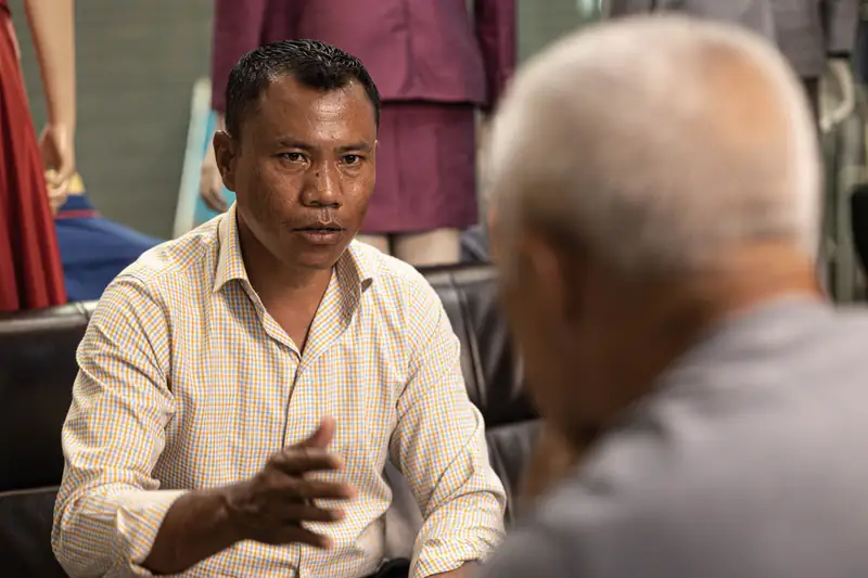 Senior tailor with fabric bolts, David Jone Fashion workshop, Patong (Ref 6279)