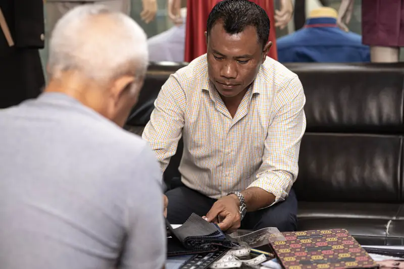Owner of New David Jone Fashion at the cutting table, Patong Phuket (Ref 6292)