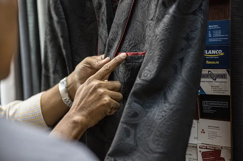 Tailor finishing lining on a custom suit, David Jone Fashion Patong (Ref 6335)
