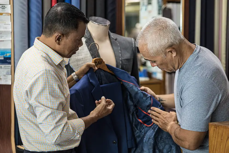 Sewing machine at work on a custom suit, Patong workshop (Ref 6358)