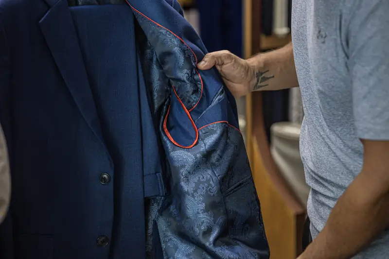 Tailor cutting cloth at David Jone Fashion workshop, Patong Phuket (Ref 6360)