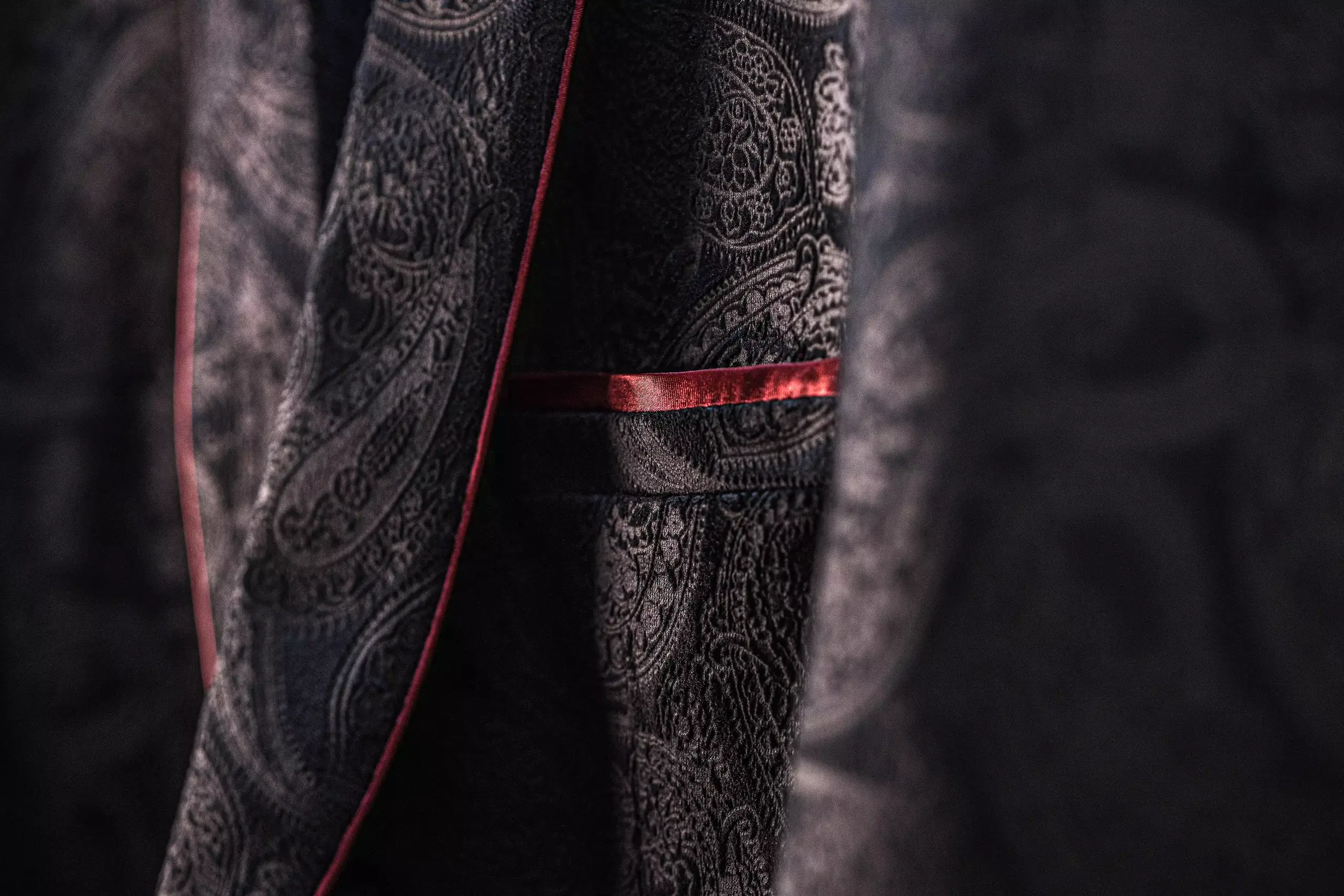 Close up of paisley woven jacket cloth with red piping