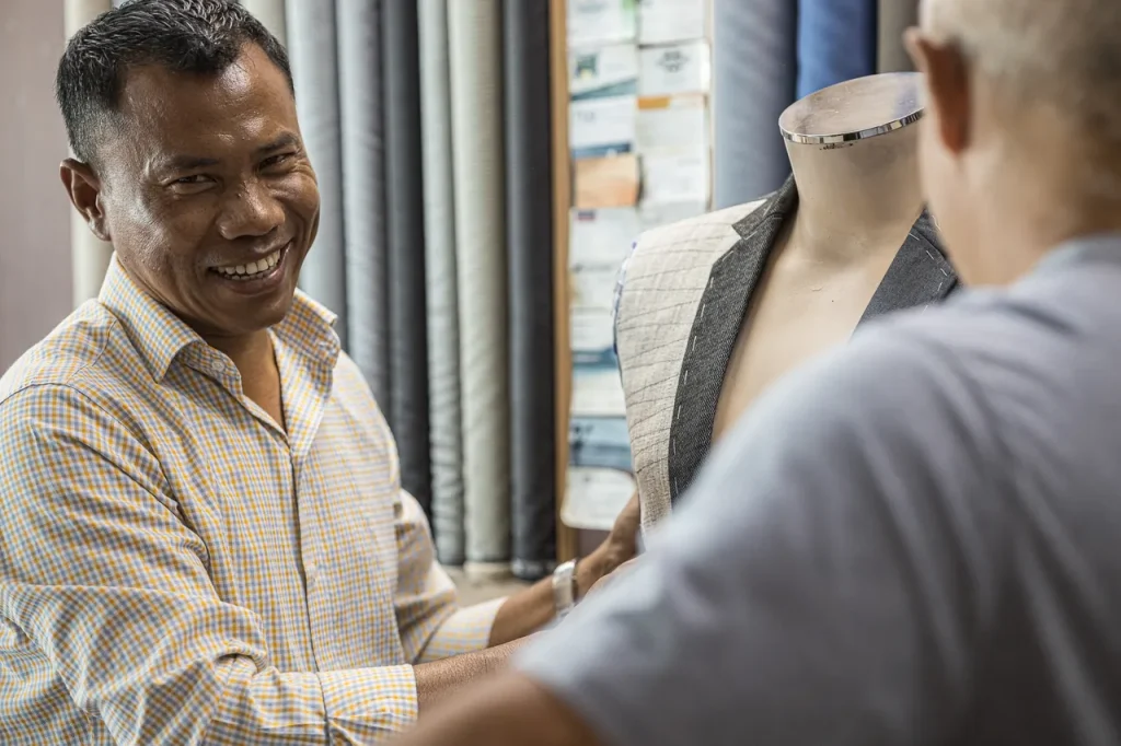 Johnny fitting a jacket on a customer in the Patong shop