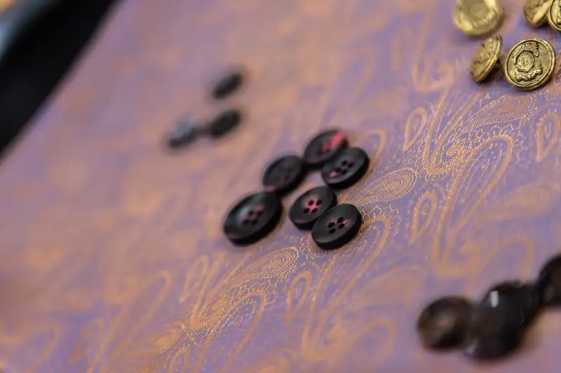 Tray of horn and mother-of-pearl suit buttons offered at the Patong workshop